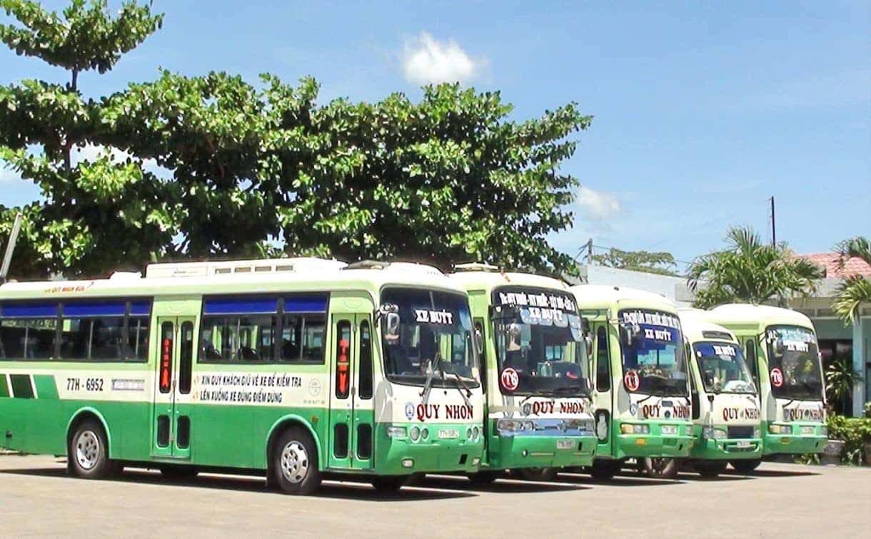 Xe buýt màu xanh nổi bật đang di chuyển trên đường phố Quy Nhơn, thể hiện sự hiện đại của hệ thống phương tiện công cộng Quy Nhơn.